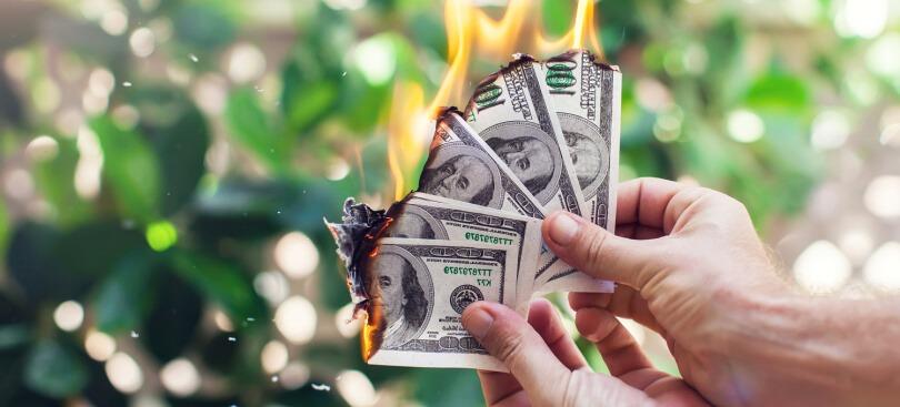Hands holding burning money