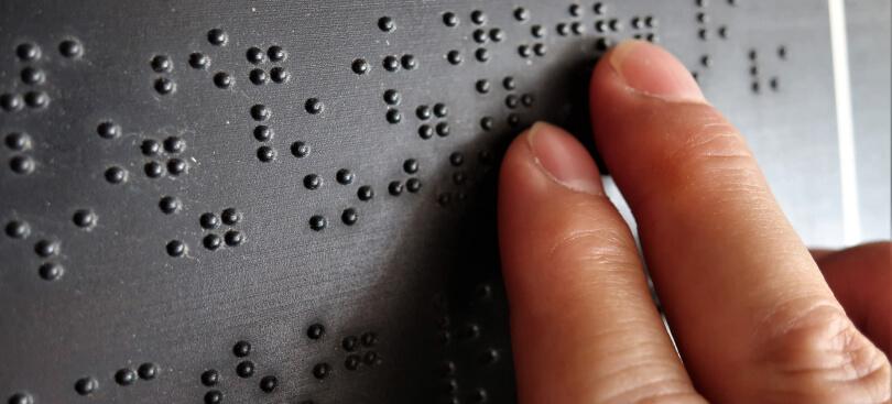 Fingers reading Braille