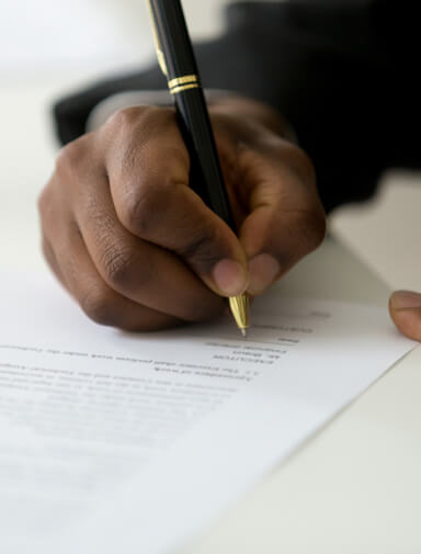 Close up of a male hand signing a document